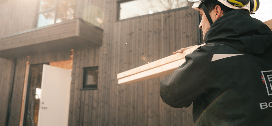 img man carrying wood panels