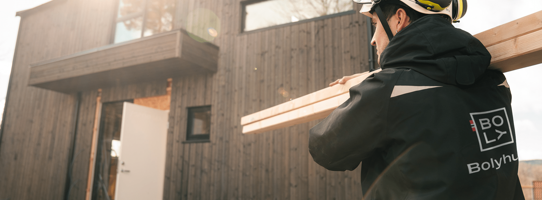 img man carrying wood panels